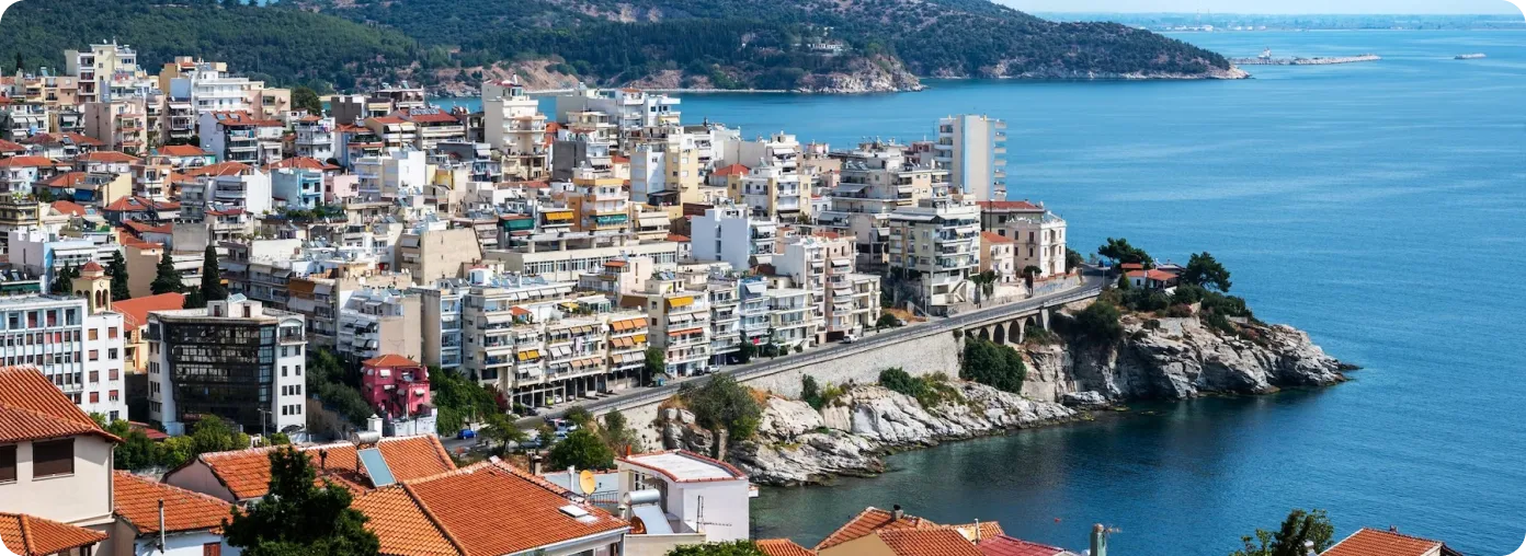 Coastal Mediterranean city with dense residential buildings and turquoise sea