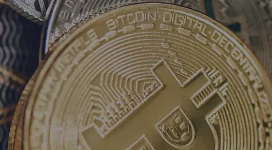 Bitcoin coin with engraved text and cross symbol