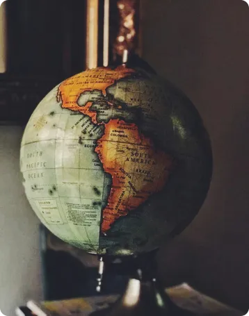 Antique terrestrial globe showing North and South America in warm tones